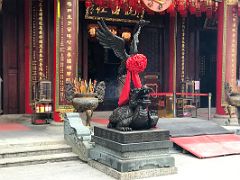 07C Statue of a crane wearing a red sash scarf on the back of a dragon tortoise outside the main hall at Wong Tai Sin temple Hong Kong